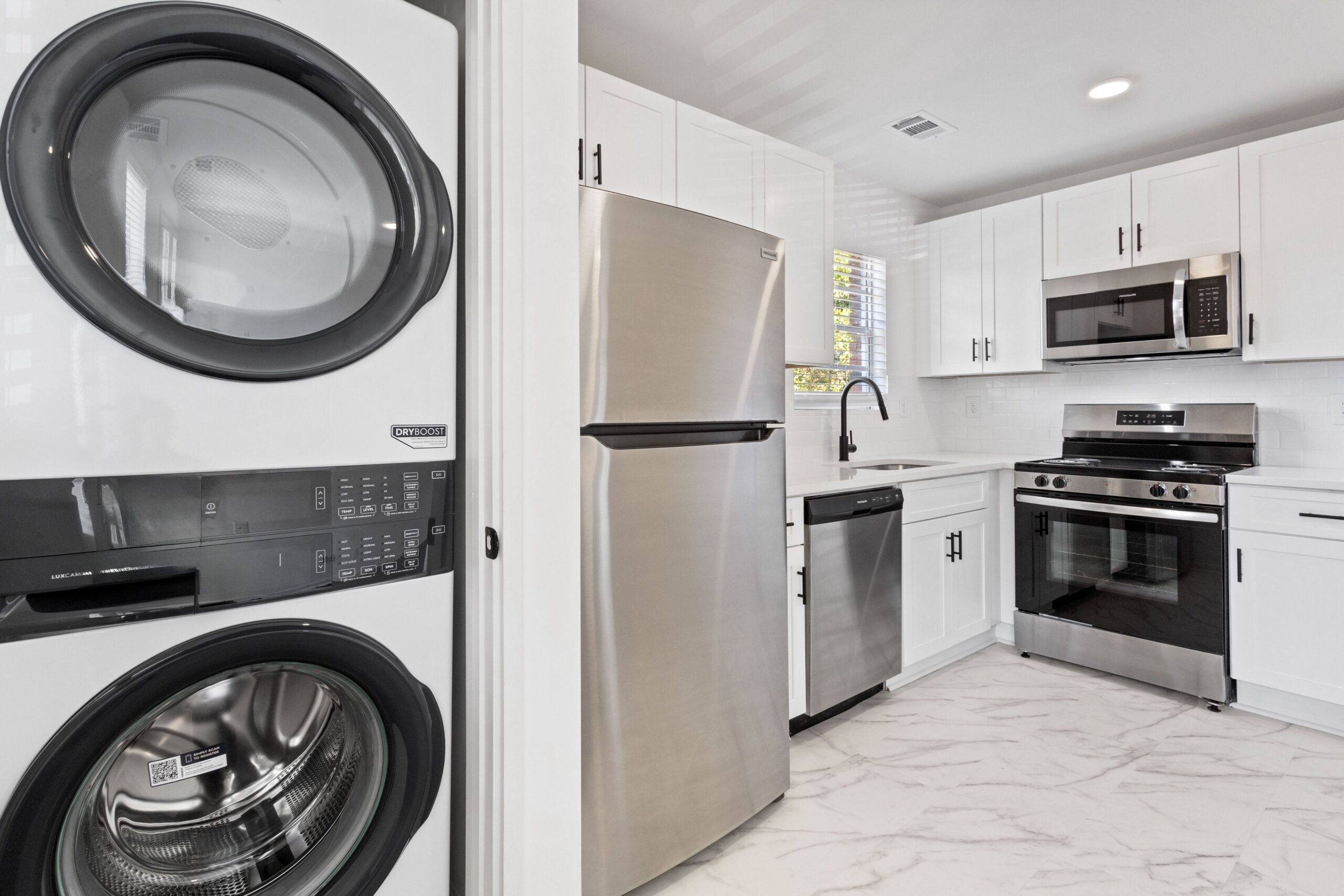Apartment kitchen with stacked laundry