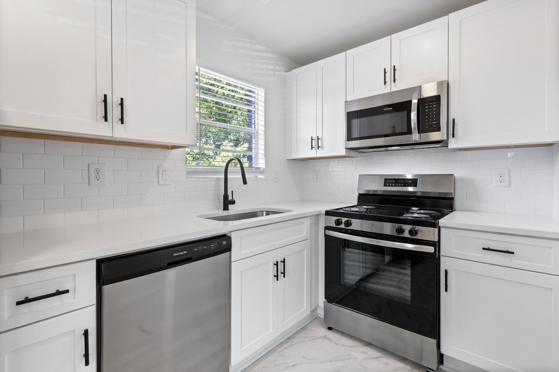 chic white kitchen with black hardware at briarcliff terrace in Atlanta